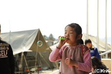 避難所となっている小学校に配られたシャボン玉で遊ぶ少女。